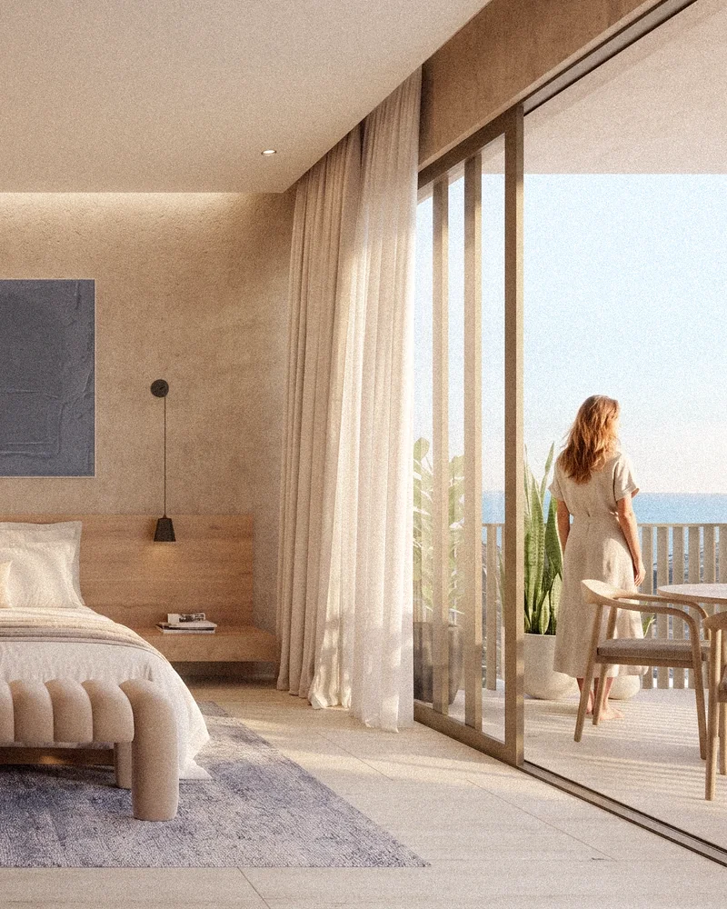 Residence bedroom opening onto an ocean-view balcony
